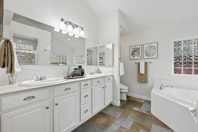 905 Juanita St, Austin, TX 78704 - bathroom with double vanity, a bath, lofted ceiling, plenty of natural light, and toilet