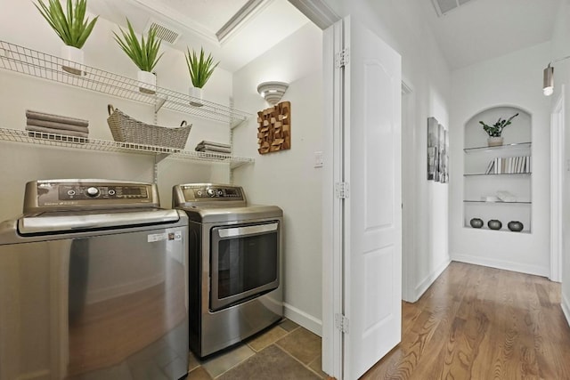 905 Juanita St, Austin, TX 78704 - laundry room with washing machine and clothes dryer, built in features, and baseboards