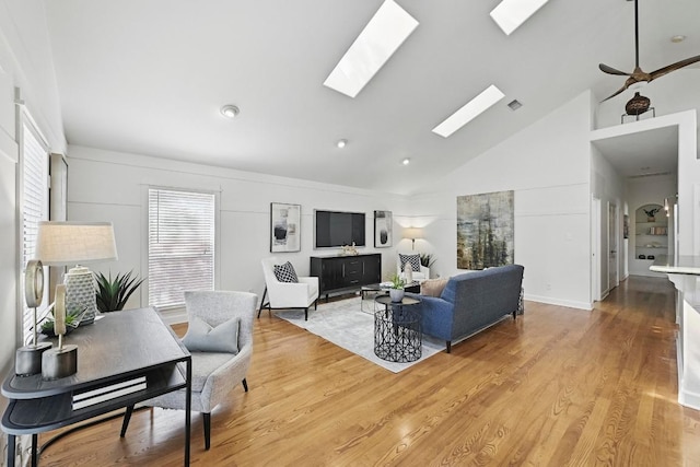 905 Juanita St, Austin, TX 78704 - living room with high vaulted ceiling, a skylight, and light wood finished floors