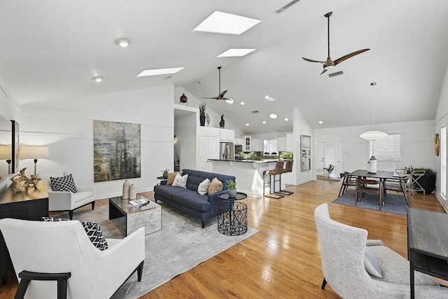 905 Juanita St, Austin, TX 78704 - living area with ceiling fan, a skylight, high vaulted ceiling, and light wood-style floors