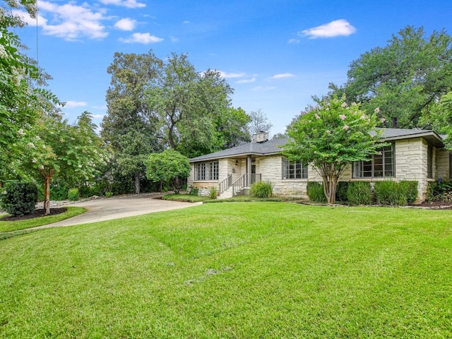 3304 Windsor Rd, Austin, TX 78703 - view of front of home featuring stone siding, a front yard, and a chimney