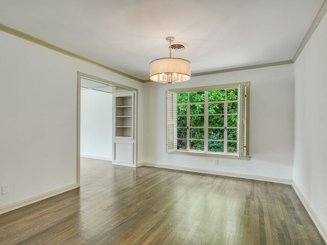 3304 Windsor Rd, Austin, TX 78703 - empty room with crown molding, wood finished floors, and a chandelier