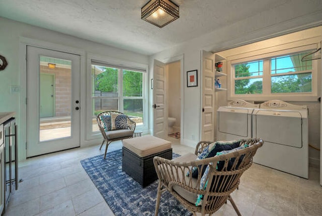 5606 Longhorn Lndg, Austin, TX 78734 - sitting room featuring washer and dryer, healthy amount of natural light, and light tile patterned floors