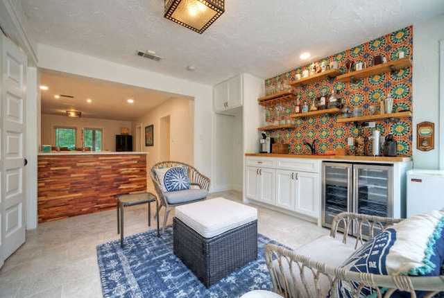 5606 Longhorn Lndg, Austin, TX 78734 - indoor wet bar featuring wine cooler, recessed lighting, and refrigerator
