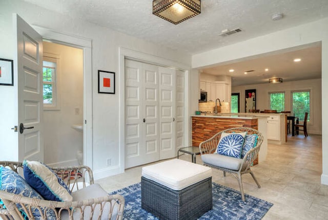 5606 Longhorn Lndg, Austin, TX 78734 - sitting room with healthy amount of natural light, baseboards, recessed lighting, and a textured ceiling