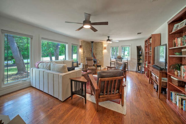 5606 Longhorn Lndg, Austin, TX 78734 - living area with a wood stove, wood finished floors, and ceiling fan