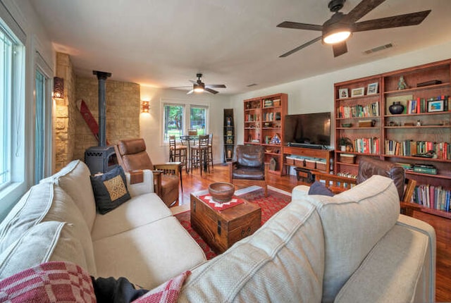 5606 Longhorn Lndg, Austin, TX 78734 - living area with a ceiling fan, a wood stove, and wood finished floors