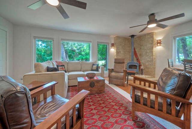 5606 Longhorn Lndg, Austin, TX 78734 - living area with a ceiling fan, a wood stove, and wood finished floors