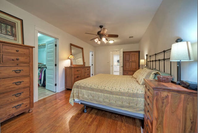 5606 Longhorn Lndg, Austin, TX 78734 - bedroom featuring a walk in closet, light wood-type flooring, a closet, and ceiling fan