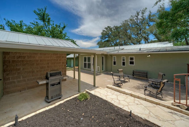 5606 Longhorn Lndg, Austin, TX 78734 - rear view of house featuring a standing seam roof, a patio, metal roof, and stucco siding