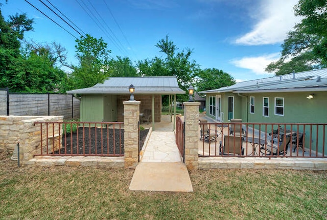 5606 Longhorn Lndg, Austin, TX 78734 - rear view of house with metal roof and an outbuilding