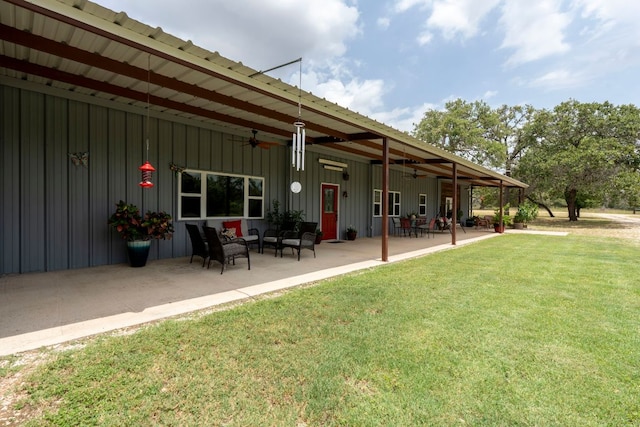966 County Road 439th Rd, Stockdale, TX 78160 - rear view of property with a ceiling fan, board and batten siding, a lawn, a patio, and an outdoor living space