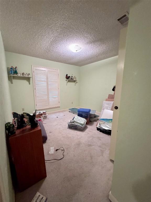 3409 Rosefinch Trl, Austin, TX 78746 - carpeted bedroom with a textured ceiling