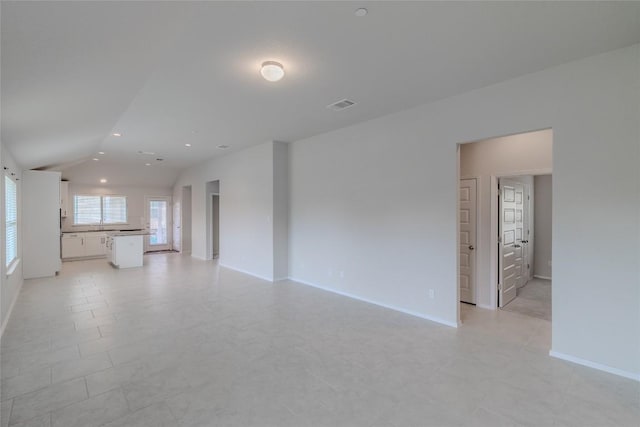 2800 Joe Dimaggio Blvd Unit 95, Round Rock, TX 78665 - unfurnished living room featuring lofted ceiling and baseboards
