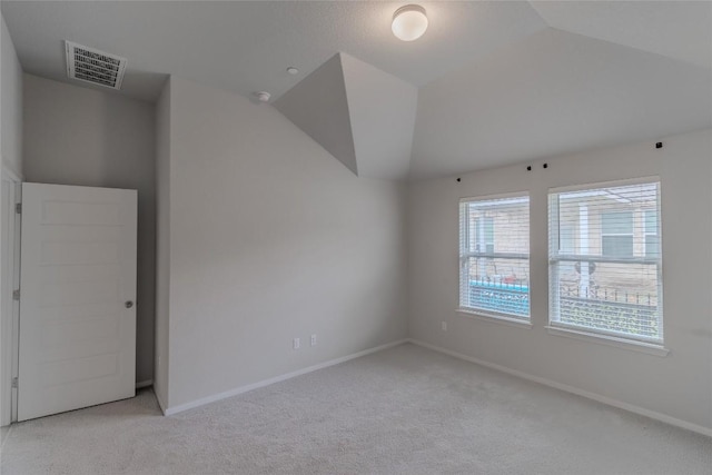 2800 Joe Dimaggio Blvd Unit 95, Round Rock, TX 78665 - spare room featuring light carpet, baseboards, and lofted ceiling