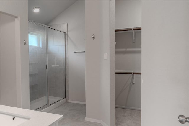 2800 Joe Dimaggio Blvd Unit 95, Round Rock, TX 78665 - full bath with a shower stall, vanity, a walk in closet, lofted ceiling, and baseboards
