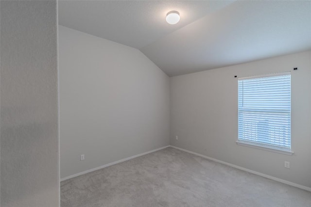 2800 Joe Dimaggio Blvd Unit 95, Round Rock, TX 78665 - unfurnished room with light colored carpet, vaulted ceiling, and baseboards