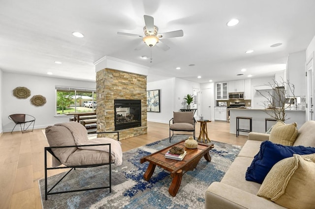 1802 Corona Dr, Austin, TX 78723 - living room featuring ceiling fan, recessed lighting, a fireplace, ornamental molding, and light wood finished floors