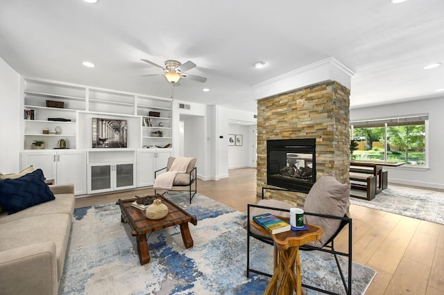 1802 Corona Dr, Austin, TX 78723 - living room featuring a fireplace, a ceiling fan, recessed lighting, wood finished floors, and crown molding
