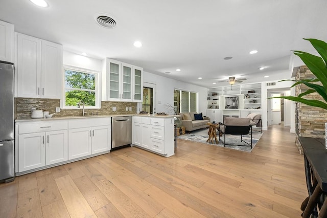 1802 Corona Dr, Austin, TX 78723 - kitchen featuring appliances with stainless steel finishes, plenty of natural light, light wood-style flooring, and recessed lighting