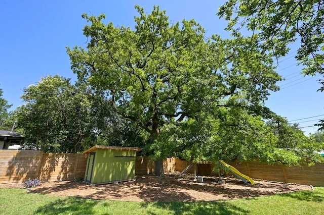 1802 Corona Dr, Austin, TX 78723 - fenced backyard with a storage unit and a playground