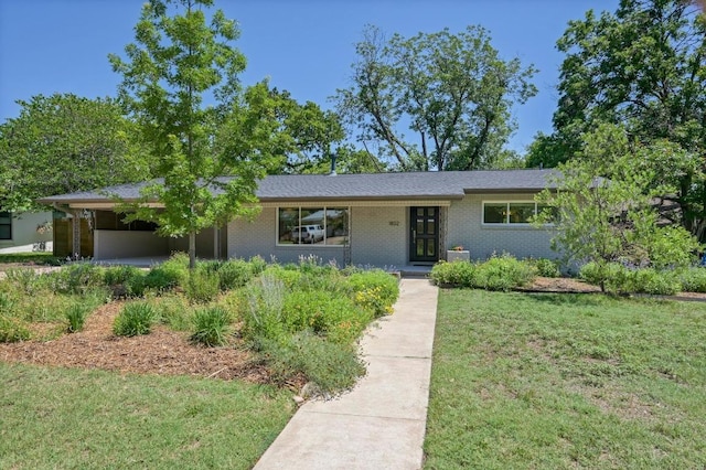 1802 Corona Dr, Austin, TX 78723 - view of front of home featuring a front yard, brick siding, and a carport
