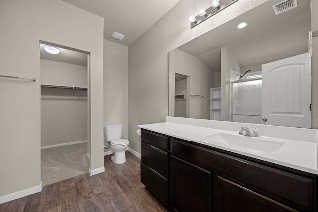 144 Sulphur River Loop, Hutto, TX 78634 - bathroom with a spacious closet, vanity, a shower with door, toilet, and wood finished floors