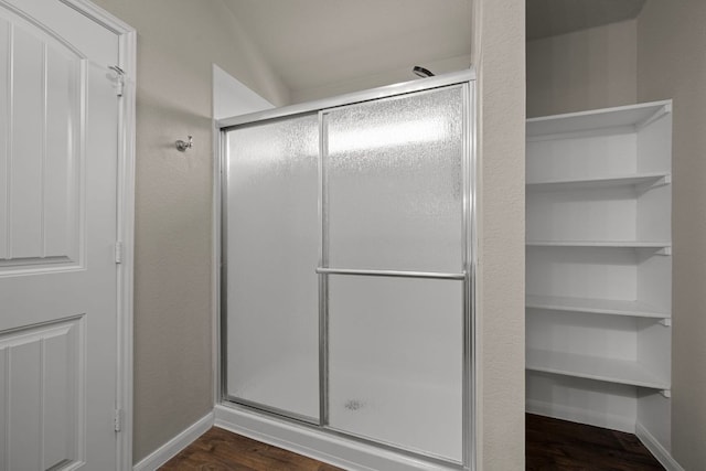 144 Sulphur River Loop, Hutto, TX 78634 - full bathroom featuring a shower stall, wood finished floors, and baseboards