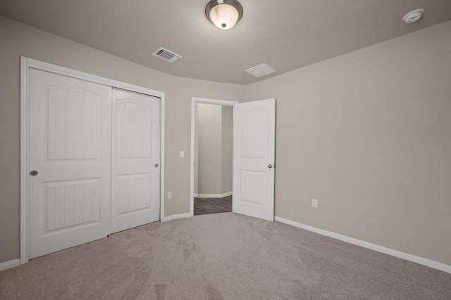 144 Sulphur River Loop, Hutto, TX 78634 - unfurnished bedroom with carpet flooring, baseboards, a closet, and a textured ceiling