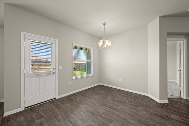 144 Sulphur River Loop, Hutto, TX 78634 - unfurnished dining area featuring a chandelier, dark wood-style floors, and baseboards
