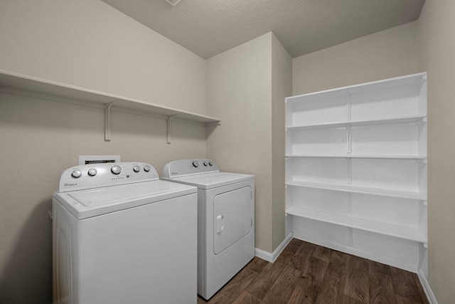 144 Sulphur River Loop, Hutto, TX 78634 - laundry area featuring washing machine and clothes dryer, dark wood finished floors, baseboards, and a textured ceiling