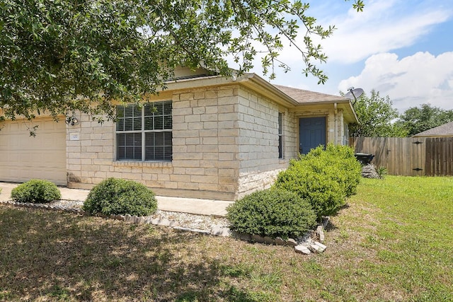 120 Wegstrom St, Hutto, TX 78634 - view of property exterior featuring an attached garage and concrete block siding