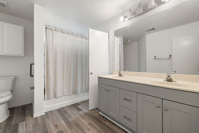 120 Wegstrom St, Hutto, TX 78634 - bathroom featuring toilet, double vanity, wood finished floors, and shower / bath combo