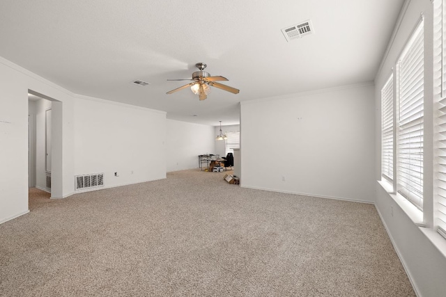 120 Wegstrom St, Hutto, TX 78634 - unfurnished living room featuring ceiling fan, crown molding, carpet flooring, plenty of natural light, and baseboards