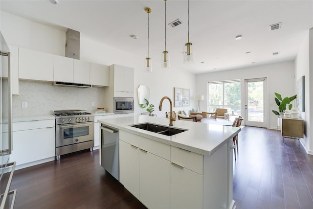 207 W Johanna St Unit 102, Austin, TX 78704 - kitchen with a sink, stainless steel appliances, extractor fan, decorative backsplash, and dark wood finished floors