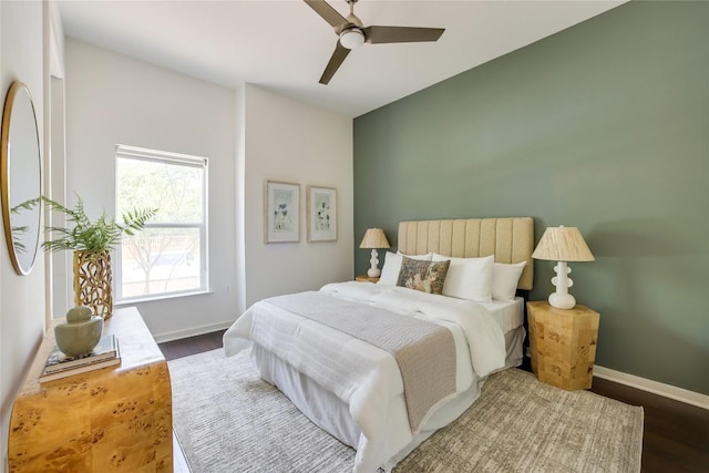 207 W Johanna St Unit 102, Austin, TX 78704 - bedroom with baseboards, wood finished floors, and a ceiling fan
