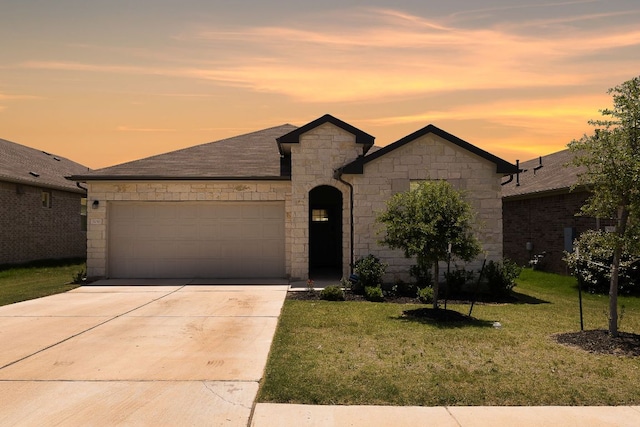809 Cade Cv, Georgetown, TX 78626 - french country inspired facade with a garage, a front lawn, concrete driveway, and stone siding