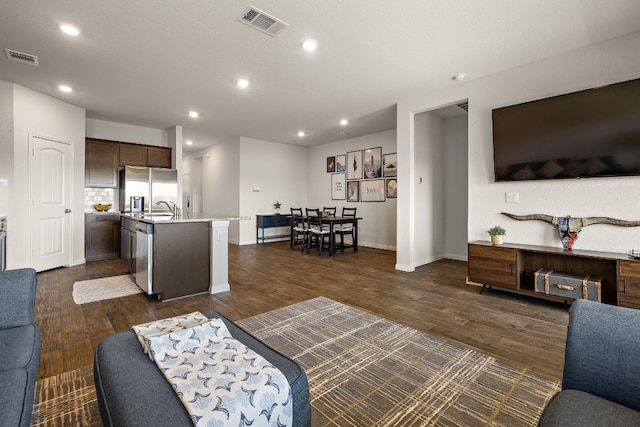 809 Cade Cv, Georgetown, TX 78626 - living room featuring dark wood-style floors, recessed lighting, and baseboards