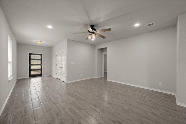 521 Rearing Mare Pass, Georgetown, TX 78626 - unfurnished living room featuring a ceiling fan, dark wood-style floors, baseboards, and recessed lighting