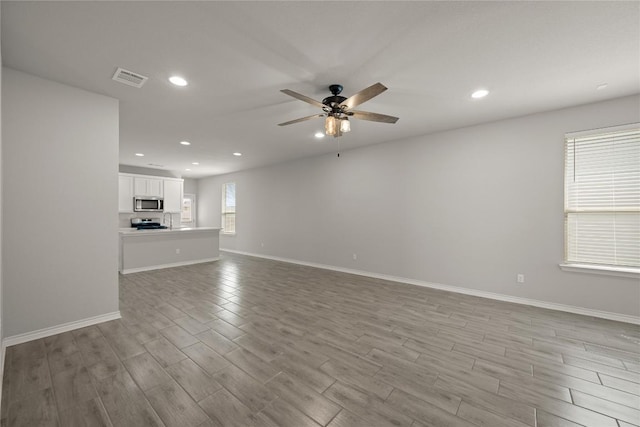 521 Rearing Mare Pass, Georgetown, TX 78626 - unfurnished living room featuring recessed lighting, ceiling fan, wood finished floors, and baseboards