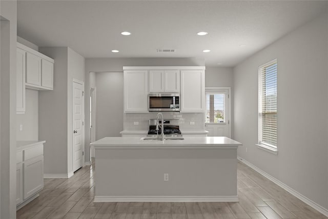 521 Rearing Mare Pass, Georgetown, TX 78626 - kitchen with stainless steel appliances, a sink, recessed lighting, tasteful backsplash, and a kitchen island with sink