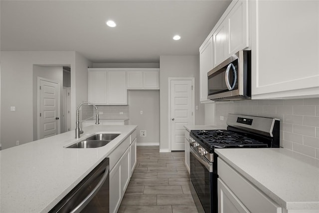521 Rearing Mare Pass, Georgetown, TX 78626 - kitchen with appliances with stainless steel finishes, a sink, white cabinets, and recessed lighting