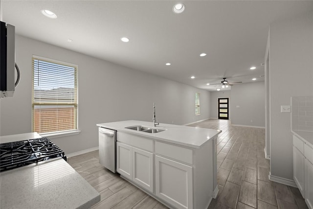 521 Rearing Mare Pass, Georgetown, TX 78626 - kitchen featuring dishwasher, a sink, wood tiled floors, recessed lighting, and baseboards