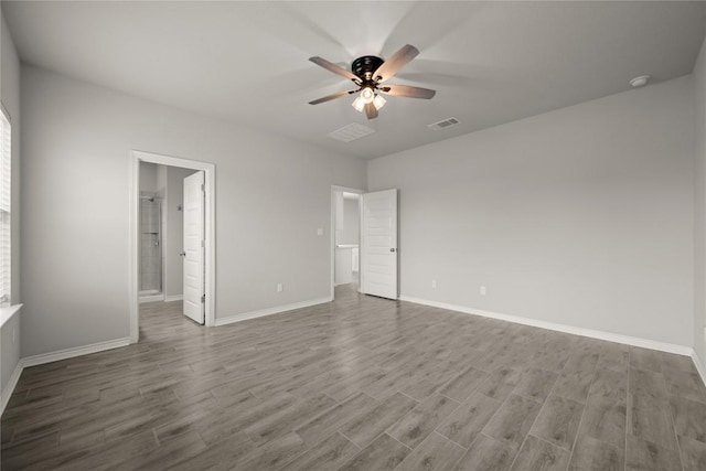 521 Rearing Mare Pass, Georgetown, TX 78626 - unfurnished bedroom with wood finished floors, baseboards, a ceiling fan, and ensuite bathroom