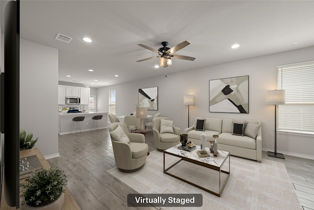 521 Rearing Mare Pass, Georgetown, TX 78626 - living area featuring light wood finished floors, baseboards, recessed lighting, and a ceiling fan