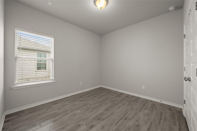 521 Rearing Mare Pass, Georgetown, TX 78626 - empty room with wood finished floors, plenty of natural light, a smoke detector, and baseboards