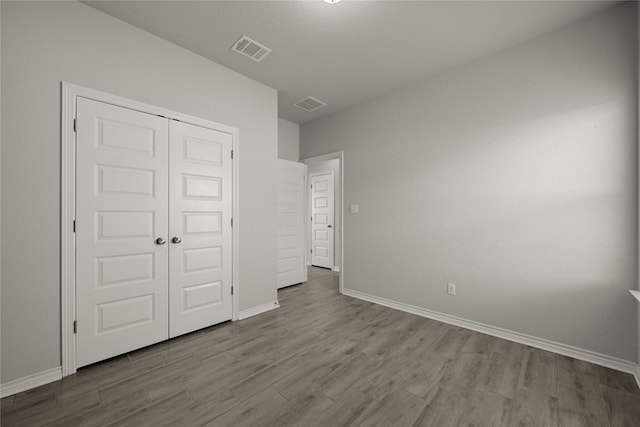 521 Rearing Mare Pass, Georgetown, TX 78626 - unfurnished bedroom featuring wood finished floors, baseboards, and a closet