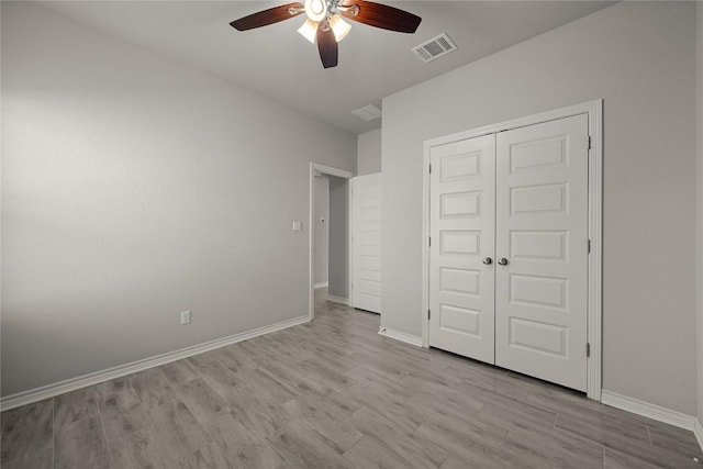 521 Rearing Mare Pass, Georgetown, TX 78626 - unfurnished bedroom with wood finished floors, a closet, baseboards, and a ceiling fan