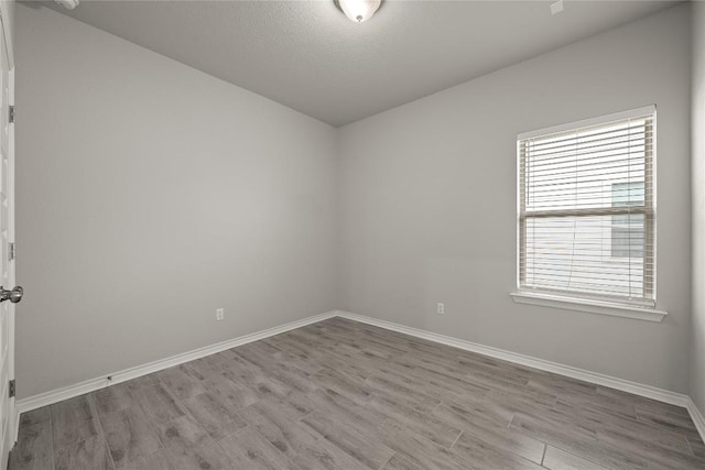 521 Rearing Mare Pass, Georgetown, TX 78626 - empty room featuring baseboards, wood finished floors, and a textured ceiling