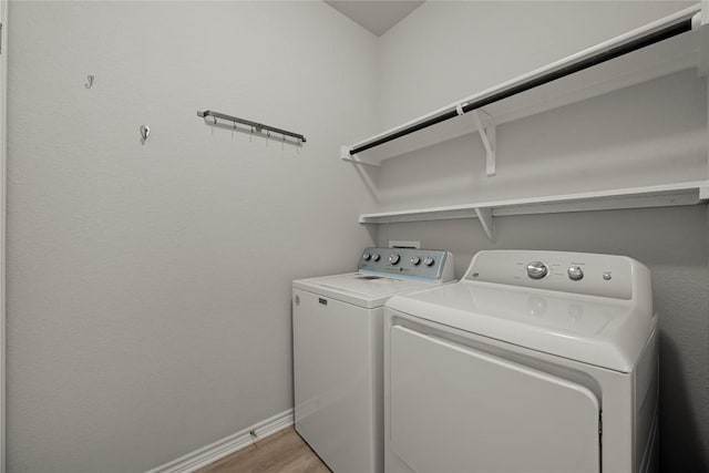 521 Rearing Mare Pass, Georgetown, TX 78626 - washroom with separate washer and dryer, light wood-style flooring, and baseboards
